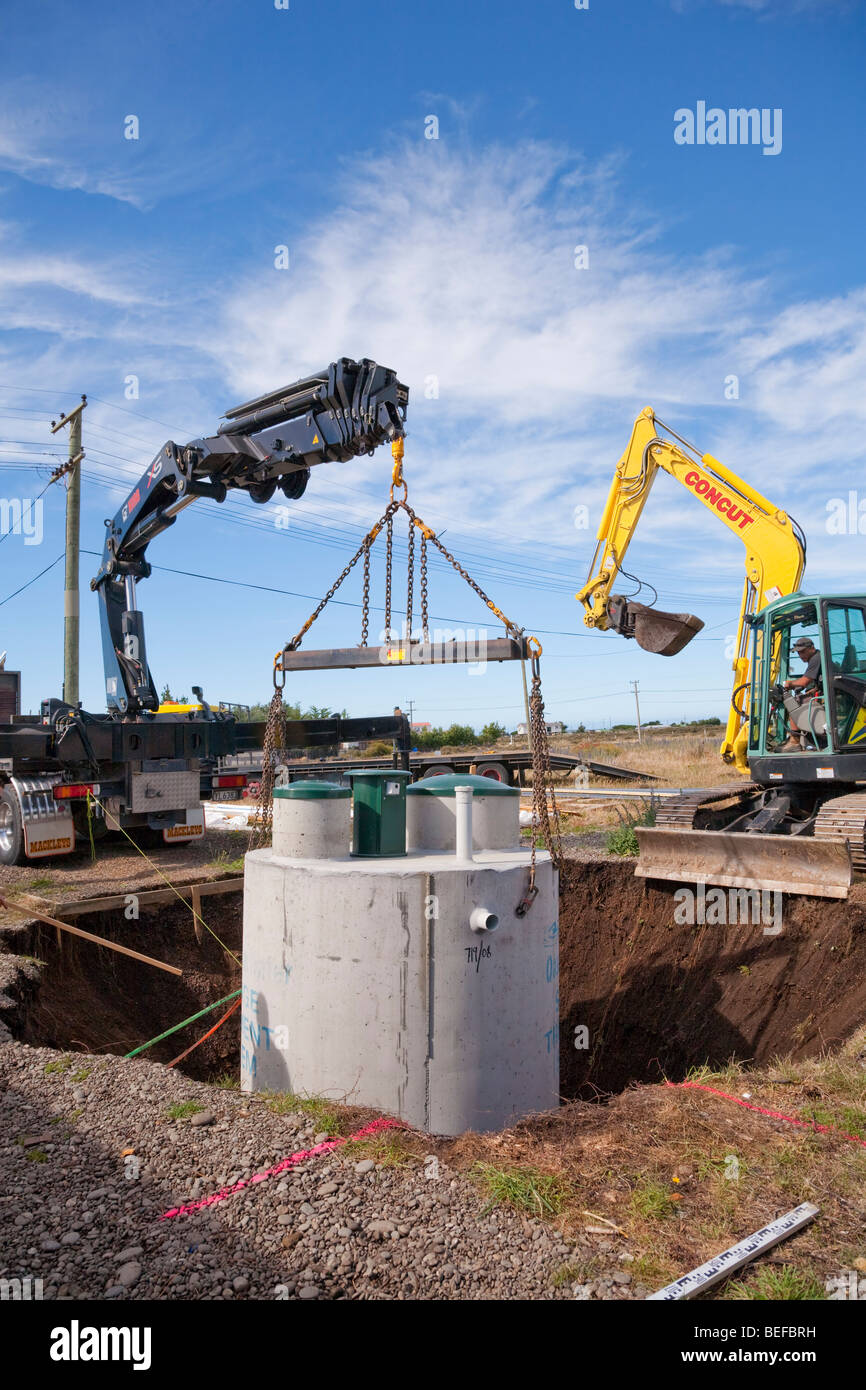 Concrete septic tank being lowered into place